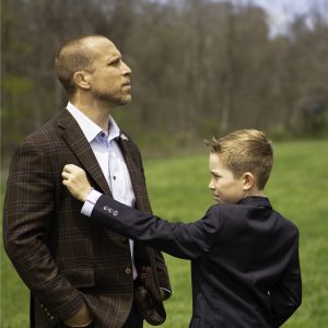 Our CEO, Duztin Watson, of the RIP Group and his Son who is lovingly fixing hi fathers suit before the photo shoot